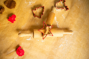 Preparation for Christmas, gingerbread baking. Two dough rolls with spruce gingerbread shape on them.