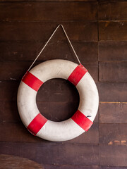 Sea lifebuoy on wooden background . Copy space for individual text.