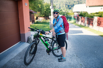 Obraz premium Young woman with helmet riding a bicycle. Enjoying sport in nature. 