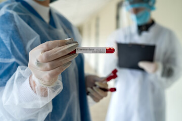 interns record the results of a laboratory test for coronavirus in a modern clinic