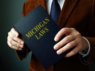 A Lawyer shows State Michigan law book.