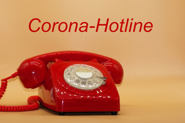 Rotes Telefon mit Schriftzug Corona Hotline