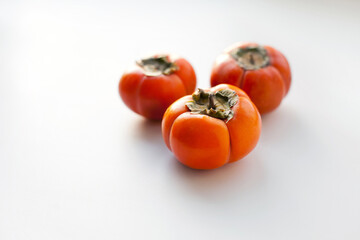persimmons on the table, orange colorted organic fruit