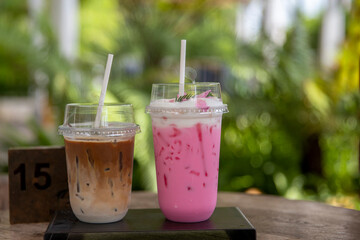 iced Pink milk, Thai style iced sweet milk with cider syrup and iced  latte coffee  on the wooden...