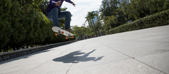 Asian woman skateboarder skateboarding in modern city © lzf