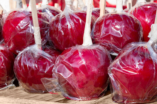 Lollipop candy caramelized red apples at street Christmas market in the European city of Plovdiv, Bulgaria. Christmas festive sweets. Xmas and holiday fair. - Powered by Adobe