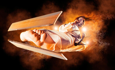 Woman in kimono practicing. Breaking board
