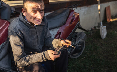 rural worker guy resting near his motorcycle