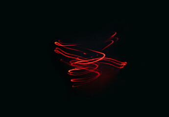 Red glowing spiral of red color on a black background. Creative texture, smooth lines swirl,...