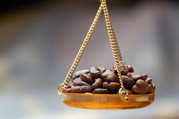 Roasted coffee beans on a scale/weighting machine