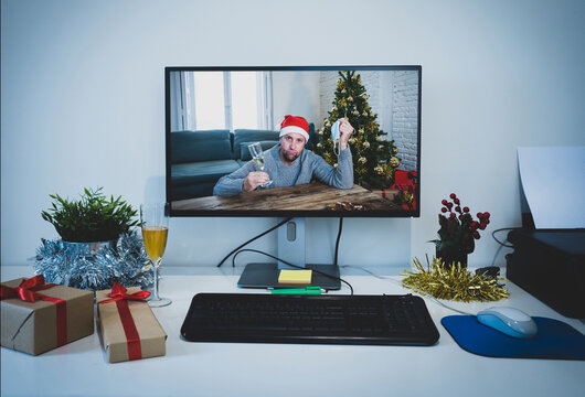 Computer Screen With Sad Man With Face Mask Home Alone On Video Call Missing Family At Christmas