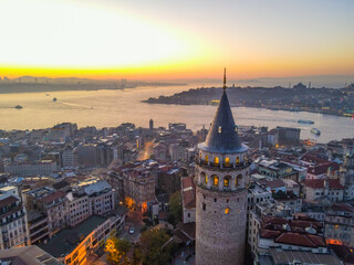 Fototapeta na wymiar Aerial Galata Tower at Sunset. Galata Bridge and Golden Horn of Istanbul with beautiful colors at Sunset. 