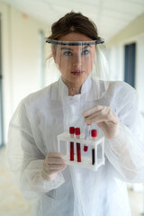 young female scientist making research with the blood sample in clinical laboratory