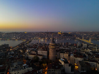 Aerial Galata Tower at Sunset. 
Galata Bridge and Golden Horn of Istanbul with beautiful colors at Sunset. 