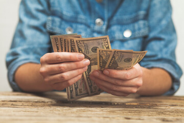 Dollars in hand, small salary. Winning the lottery. - obrazy, fototapety, plakaty