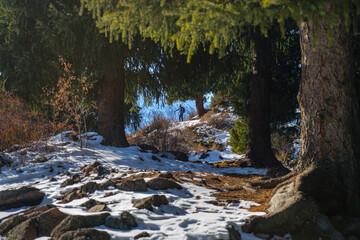 Mountain winter view with male traveler in the background. Outdoor hiking in the mountains in winter