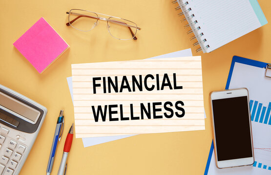 Paper With Text Financial Wellness Near Office Supplies.