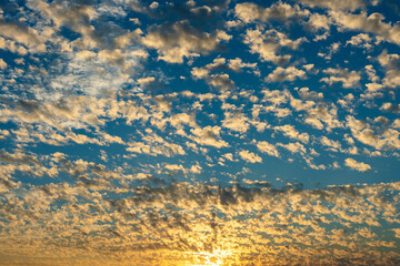 Colorful altocumulus clouds at dusk. Beautiful natural scenery background.