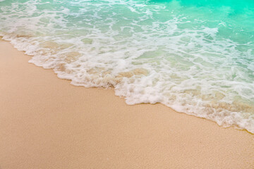 Fototapeta na wymiar Soft wave and sea bubble of blue sea on sandy beach