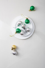 Christmas baubles fron above on stone plate