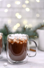 glass cup of cocoa on the buckground of gold bokeh, New Year hot drink