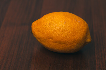 Yellow juicy lemon isolated on a wooden background. Citrus fruits. Close-up. The preparation of drinks