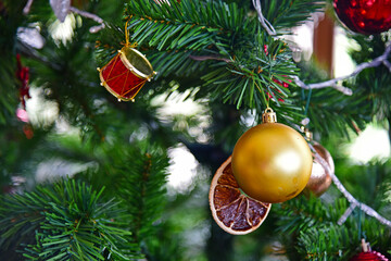 Close up gold ball and toys decorating the chrismas tree.