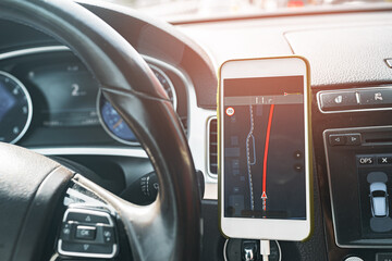 Smartphone with open gps navigation app on torpedo in car