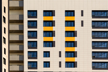 A row of windows on the ventilated facade of a typical modern residential building. Fragment of a...
