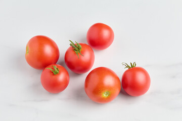 ripe organic red colored tomatoes close-up on a marble background. flat lay, top view