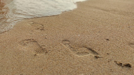 footprints on the sand by the sea