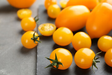 Ripe yellow tomatoes on grey table, closeup