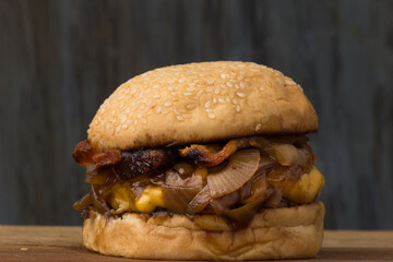 Delicious Cheddar Cheese Burger with Caramelized Onions and Bacon