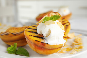 Delicious grilled peach with ice cream served on plate, closeup