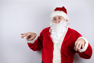 Fototapeta na wymiar Man dressed as Santa Claus standing over isolated white background disgusted expression, displeased and fearful doing disgust face because aversion reaction. Annoying concept