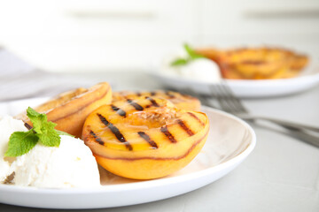 Delicious grilled peaches with ice cream and honey on grey table, closeup