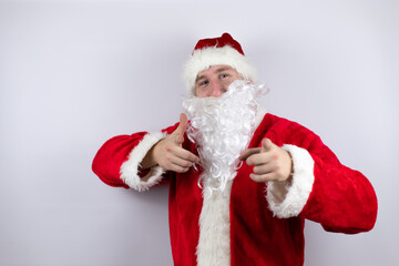 Fototapeta na wymiar Man dressed as Santa Claus standing over isolated white background pointing to the camera with fingers, smiling positive and cheerful