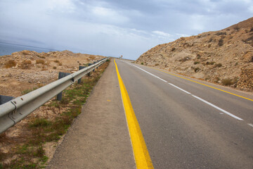 Asphalt road leading up to the clouds.