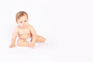 baby six months old in diapers on white isolated background, space for text