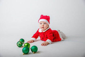 Fototapeta na wymiar a baby in a Santa Claus costume on a white background