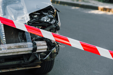 Police tape on road in front of car accident. Crashed Suv car in road traffic accident. Cars...