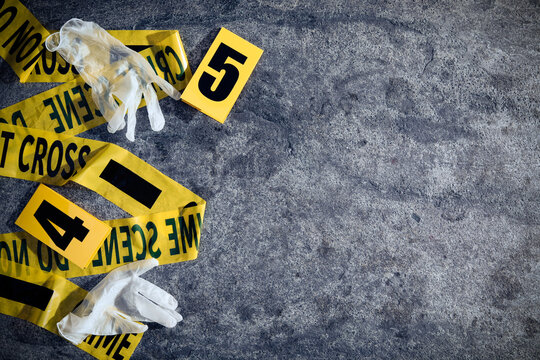 Crime scene markers, tape and gloves on grey stone table, flat lay