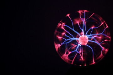 High-voltage arc at coil of Tesla. Plasma lamp. Abstract concept of electric power