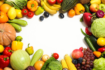 Frame of assorted fresh organic fruits and vegetables on white background, top view. Space for text
