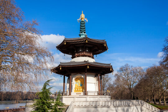 The Peace Pagoda in Battersea Park London England with gilded bronze gold Buddha statues which is a popular travel destination tourist attraction landmark of the city, stock photo image