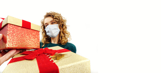 Woman wearing green is giving a Christmas present during pandemic, white background isolated