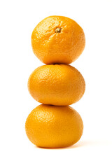 Tangerine snowman. Three tangerines lined up on top of each other in the shape of a snowman.