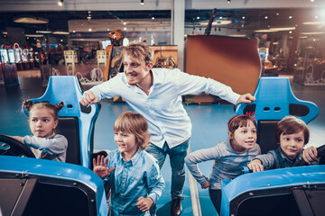 Children playing slot machines in the center. 