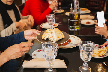 Family together having Christmas dinner in restaurant.