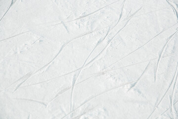Ice Rink Texture with traces of ice skating. Selective focus of Skate marks on the ice.